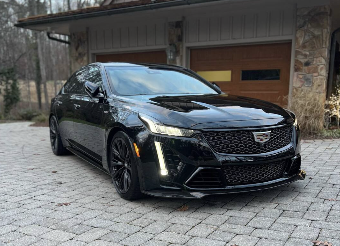 Black luxury sedan with a deep gloss finish after a full exterior detail